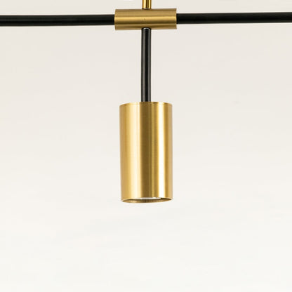 Close view of gold light fixtures on black frame showing brushed metallic finish and fine craftsmanship with elegant detailing.