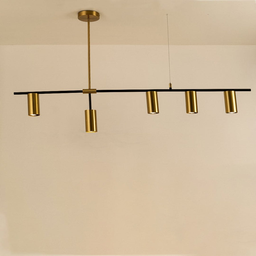 Sleek gold linear chandelier illuminated on white background showcasing minimalist design perfect for dining tables and modern interiors.
