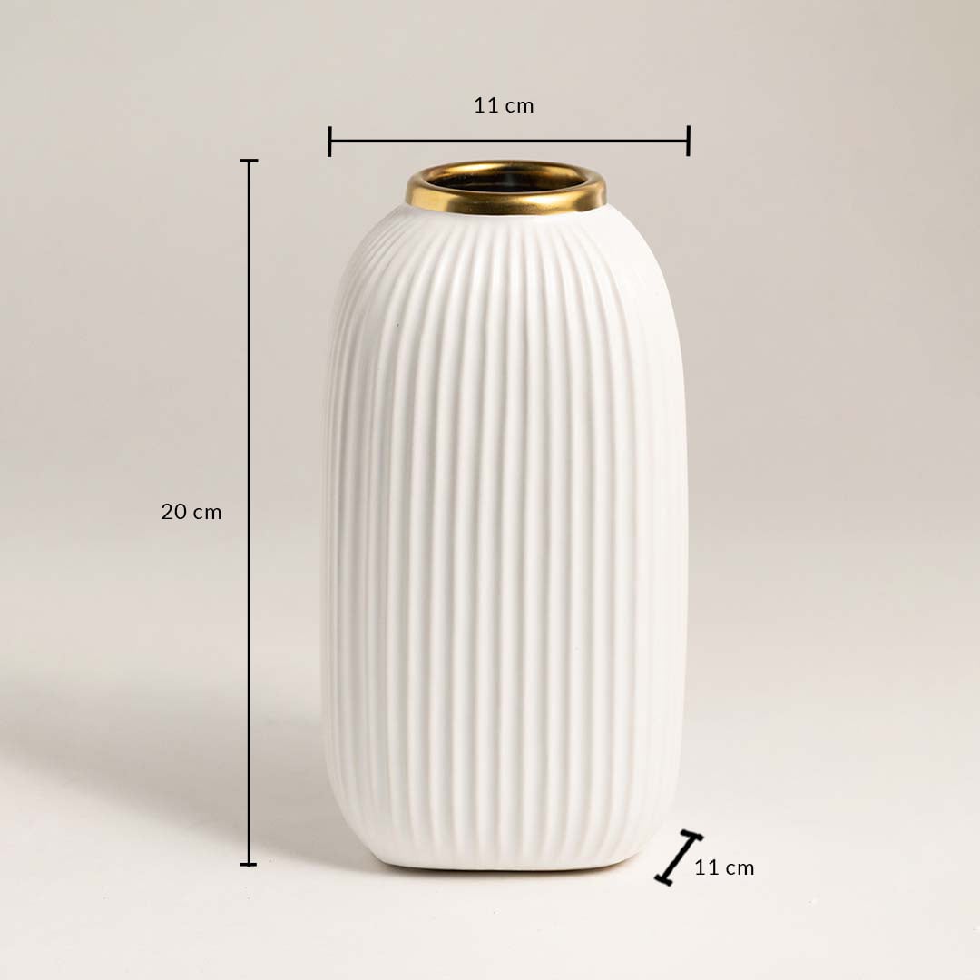 White ribbed ceramic vase with gold rim measuring 20 cm height and 11 cm width ideal for table or shelf décor.