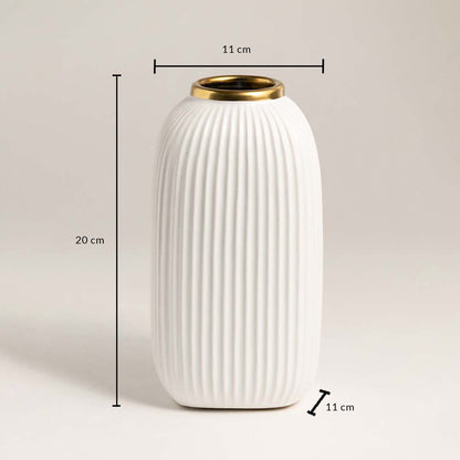 White ribbed ceramic vase with gold rim measuring 20 cm height and 11 cm width ideal for table or shelf décor.