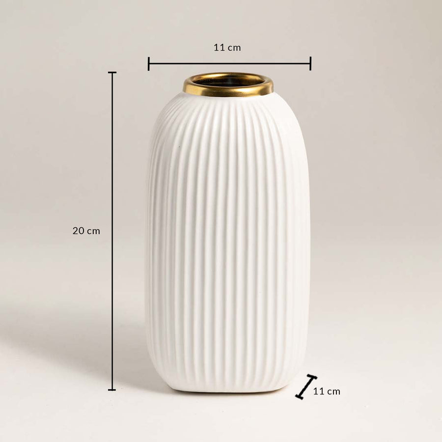 White ribbed ceramic vase with gold rim measuring 20 cm height and 11 cm width ideal for table or shelf décor.