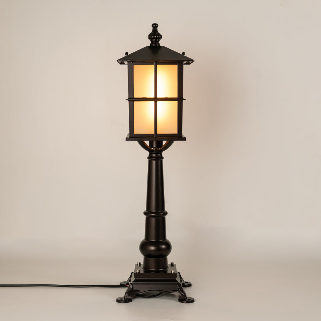 Black outdoor gate light with warm glowing panels for luxury exterior decor styling use.