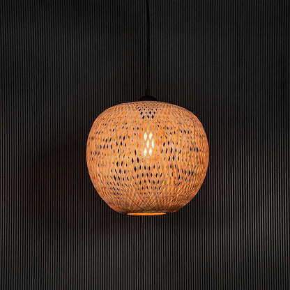 Round rattan pendant light with handwoven bamboo shade turned on glowing softly against plain black background.
