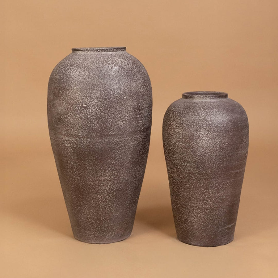 Brown rustic tall decorative vase arranged with matching decor pieces creating a stylish grouped display for warm contemporary interior settings.