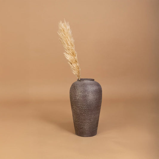 Brown rustic tall vase placed in a curated home setting enhancing consoles shelves and living spaces with natural earthy decorative appeal.