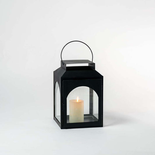 Black lantern with matte finish captured under neutral lighting on a white backdrop for product detailing.