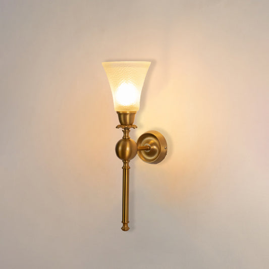 Gold metal wall light with frosted glass shade on white background ideal for bedroom hallway and living room lighting.