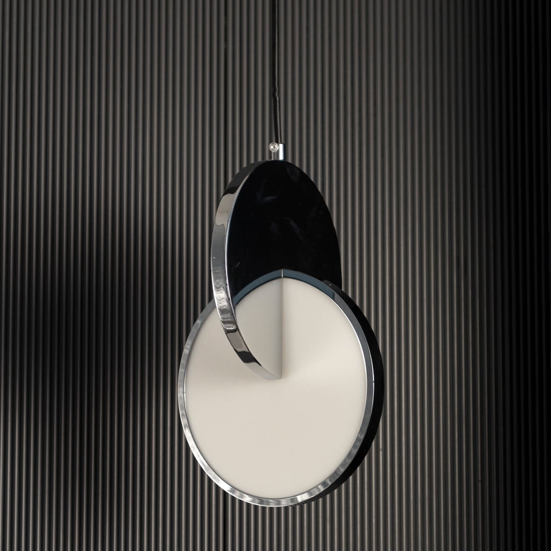 Luna disc pendant light turned off highlighting sleek round metal and frosted glass design against dark backdrop.