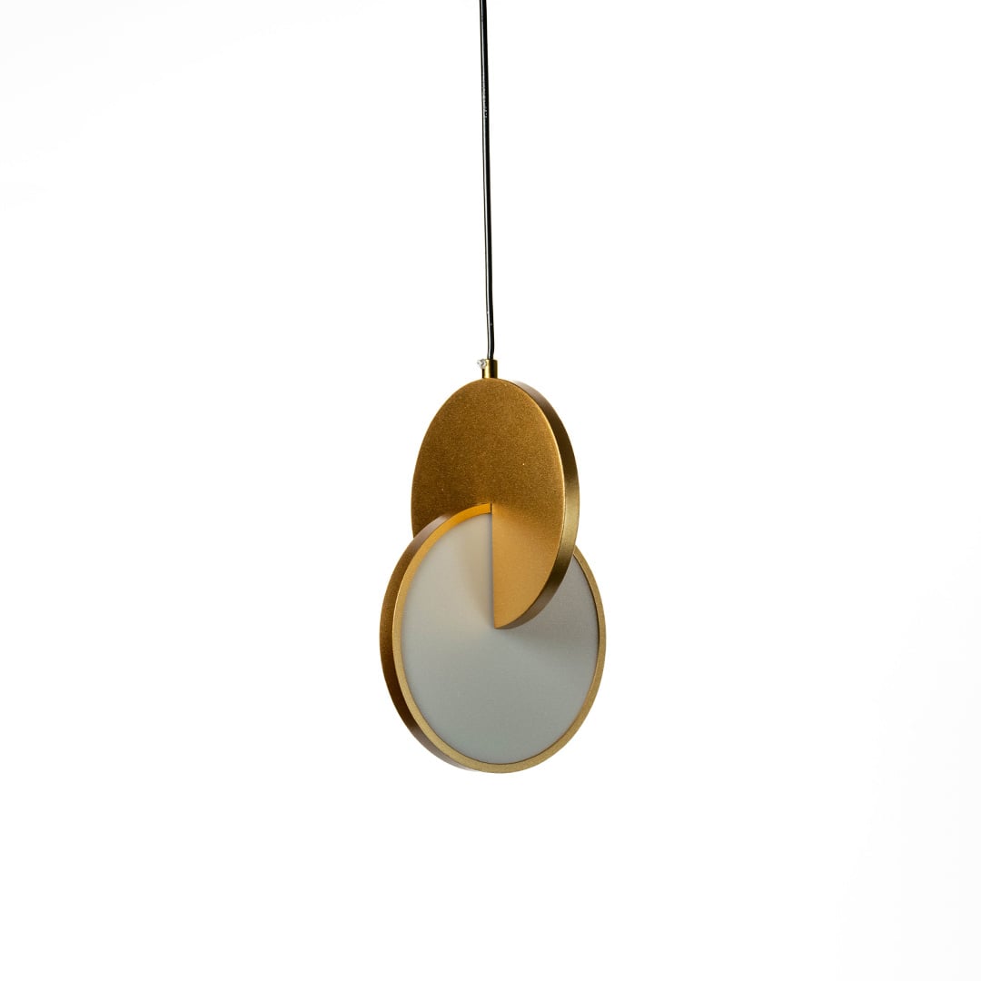 Luna disc pendant light turned on highlighting smooth metallic curves and soft warm light glow against a dark background.