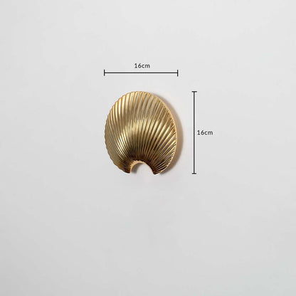A gold shell decor piece shown with clear dimension markers displaying 16 cm height and 16 cm width highlighting its compact artistic form for accurate product reference.