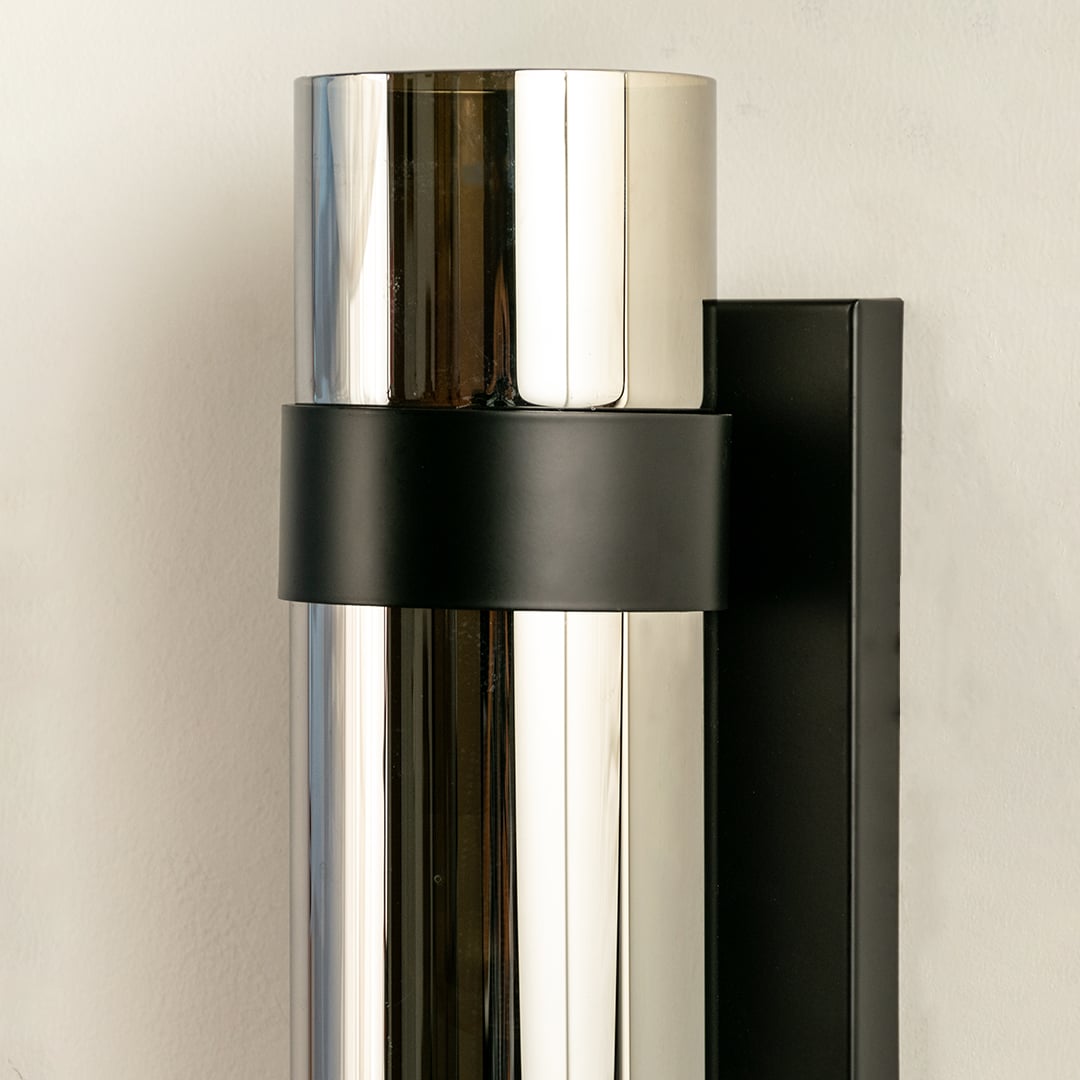 Sleek cylindrical silver and black modern wall light ideal for contemporary décor providing stylish up down illumination for living areas and hallways.