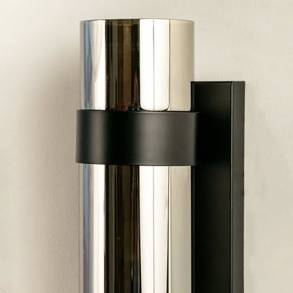 Sleek cylindrical silver and black modern wall light ideal for contemporary décor providing stylish up down illumination for living areas and hallways.