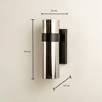 Sleek silver and black cylindrical wall light shown with height 30 cm width 10 cm and depth 12 cm ideal for modern exterior and interior décor lighting.