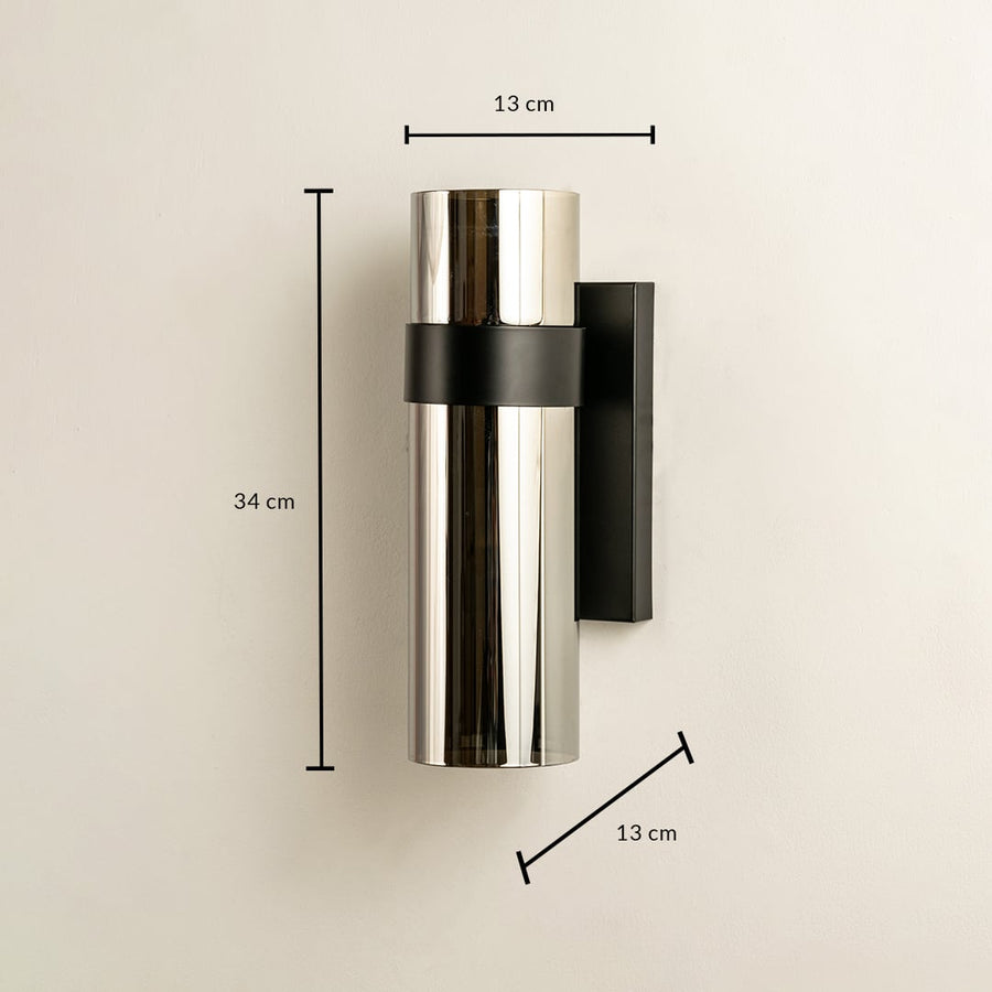 Sleek silver and black cylindrical wall light shown with height 30 cm width 10 cm and depth 12 cm ideal for modern exterior and interior décor lighting.