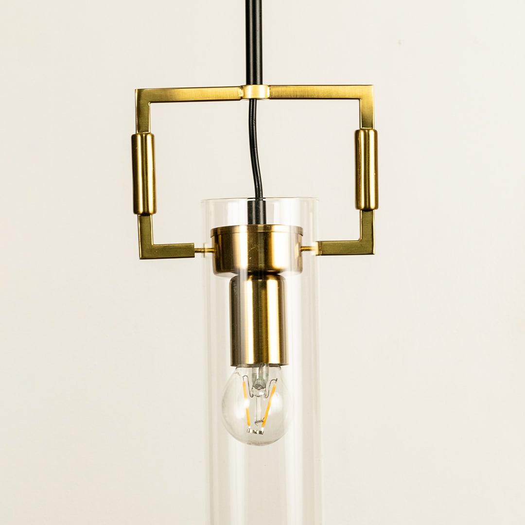 A gold geometric pendant light with a square frame and glass cylinder ideal for modern LED chandelier décor and stylish contemporary interior lighting.