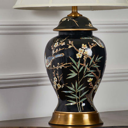 Closeup of black ceramic table lamp with light off capturing detailed floral artwork gold accents and smooth glossy finish for premium decor.