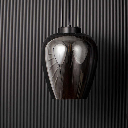 Smoked glass pendant light with sleek black suspension displayed off on black background for modern luxury interiors.
