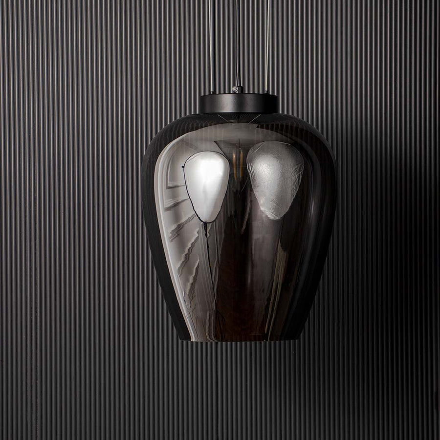 Smoked glass pendant light with sleek black suspension displayed off on black background for modern luxury interiors.