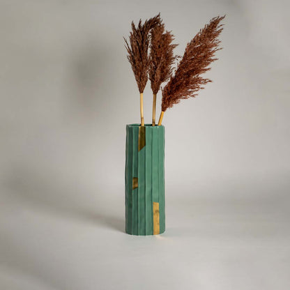 Green ceramic vase with vertical ribbed texture and gold accents displayed on a clean white background ideal for modern home decor styling.