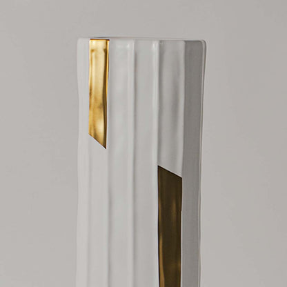 Closeup view of the tall ribbed vase with gold detailing showing the smooth finish and geometric accents that enhance its stylish decorative appeal.