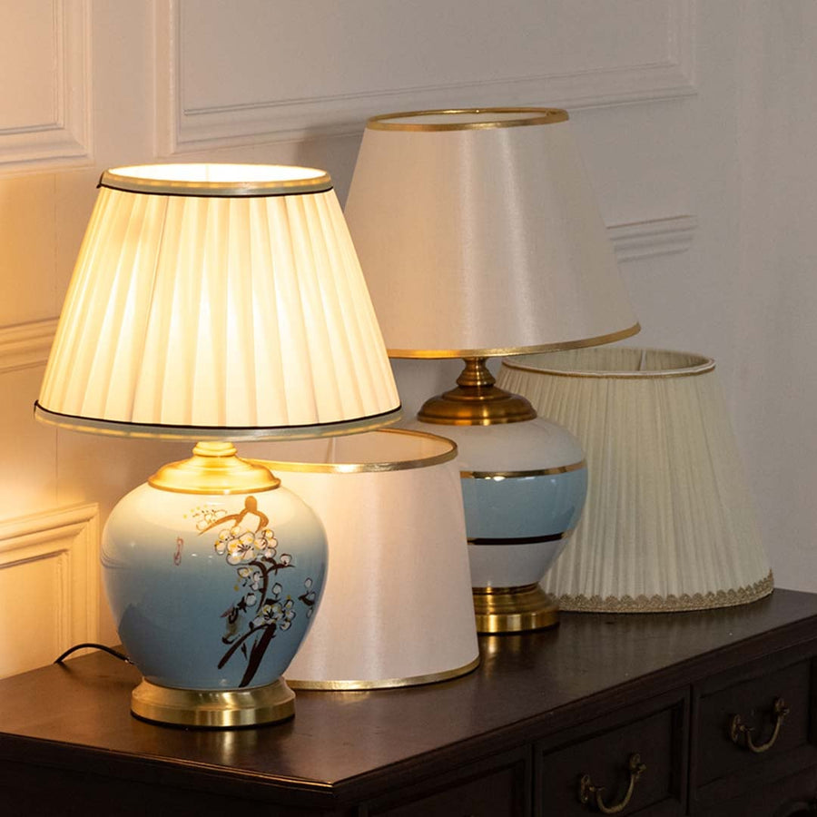 Table lamp with blue ceramic base and pleated white shade displayed in a coordinated decor scene for premium styling.