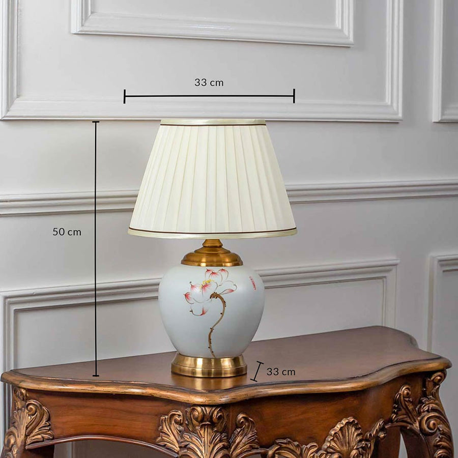 Ceramic table lamp with pleated shade shown with 50cm height and 33cm width on white background.