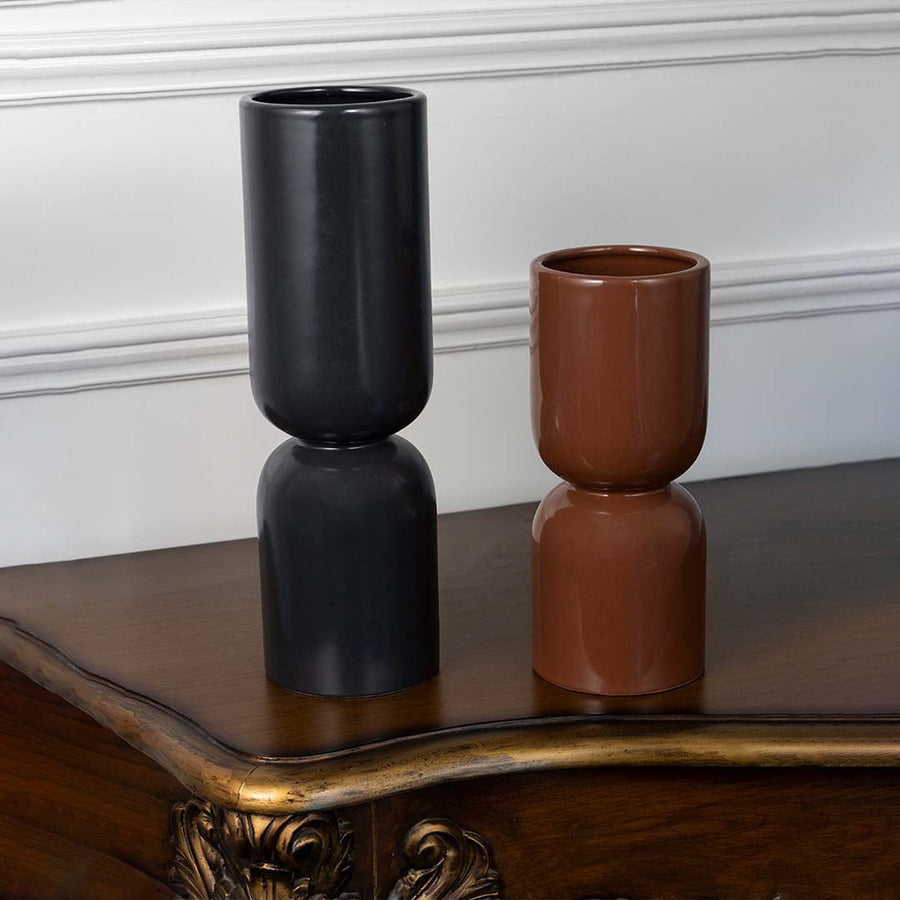 Stylish brown ceramic vase with double cylinder shape shown on white background for minimalist room styling.