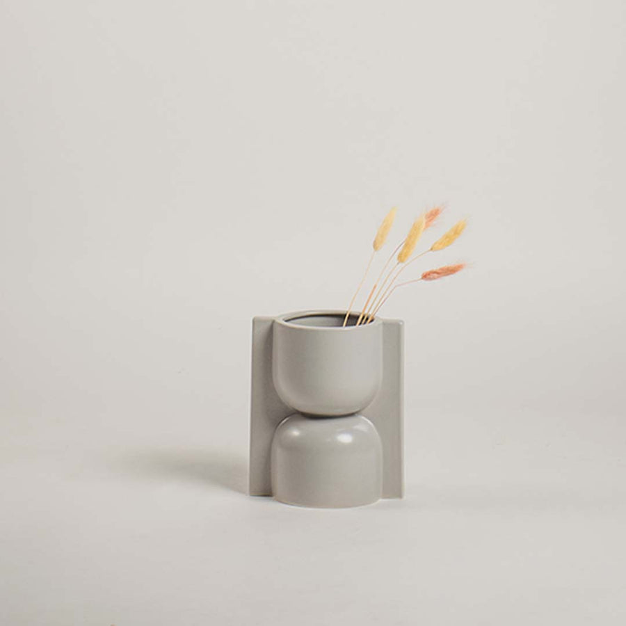 Modern light grey ceramic vase with sculptural geometric design shown on a plain white background perfect for refined minimal styling.