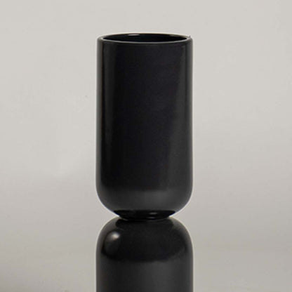 Closeup of black ceramic decorative vase with smooth matte finish showcasing modern craftsmanship and luxury decor.