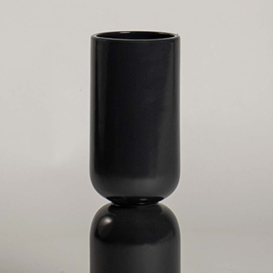 Closeup of black ceramic decorative vase with smooth matte finish showcasing modern craftsmanship and luxury decor.