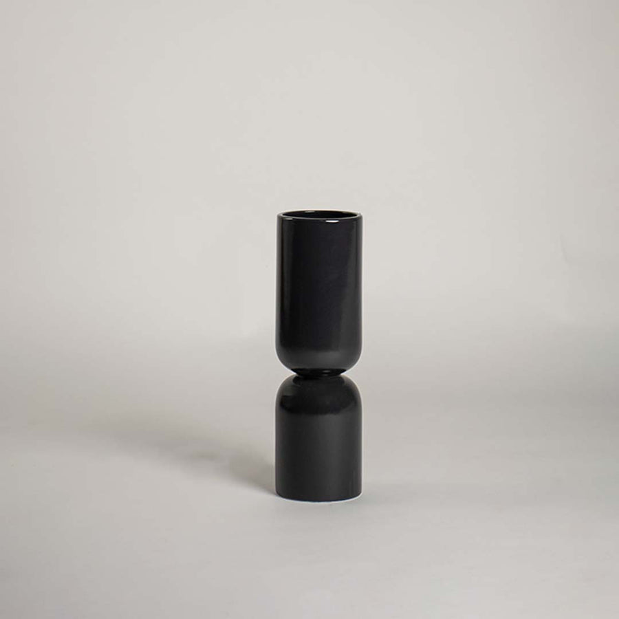 Modern black double form ceramic vase placed on a white background ideal for minimal styling and sophisticated home decor accents.