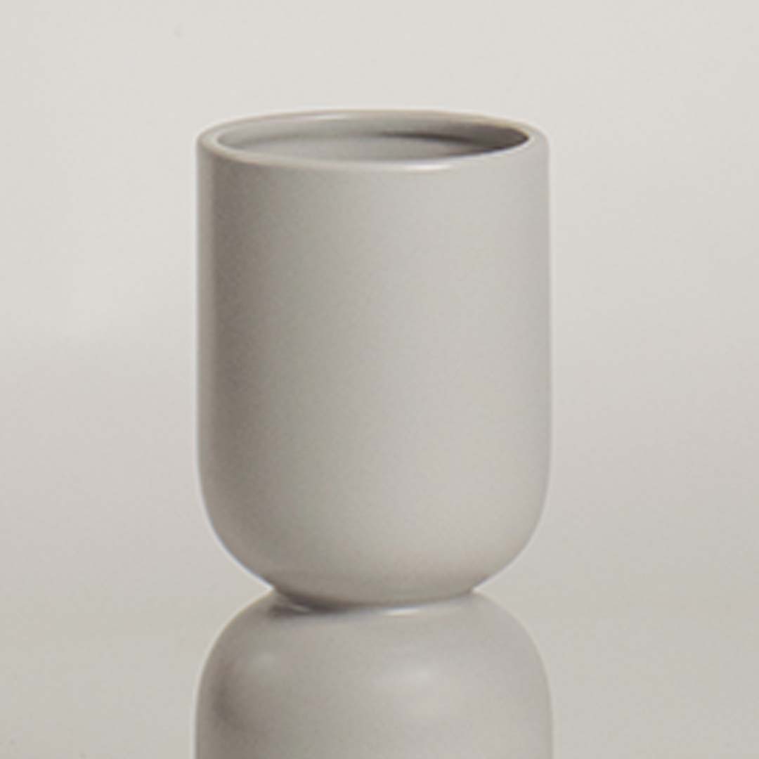 Closeup of light grey ceramic vase featuring its smooth matte finish and sculptural double form ideal for stylish minimal decor.