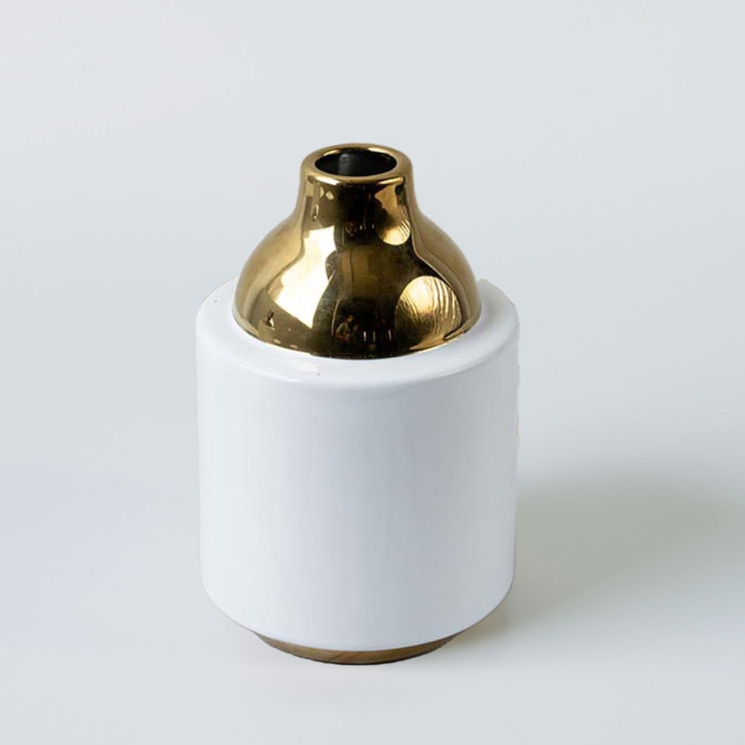 White ceramic decorative vase with metallic gold neck detail for tabletop styling and contemporary home decor displays.