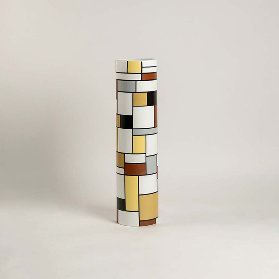 Modern geometric ceramic vase displayed on a clean white background showcasing bold multicolor block patterns perfect for contemporary decor styling.