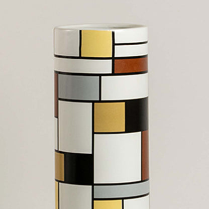 Closeup of geometric ceramic vase showing detailed block pattern and textured colors creating a bold artistic accent for contemporary decor.