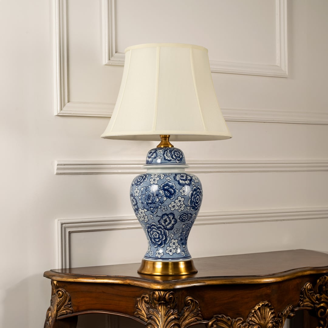 Blue and white ceramic table lamp with classic floral pattern and fabric shade for timeless decorative table lighting.