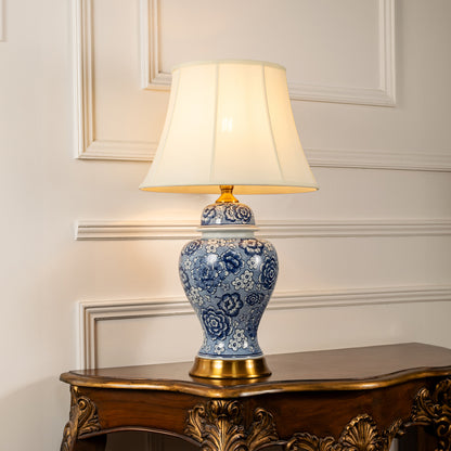 Blue and white ceramic table lamp with fabric shade designed for elegant traditional decor and ambient lighting indoors.