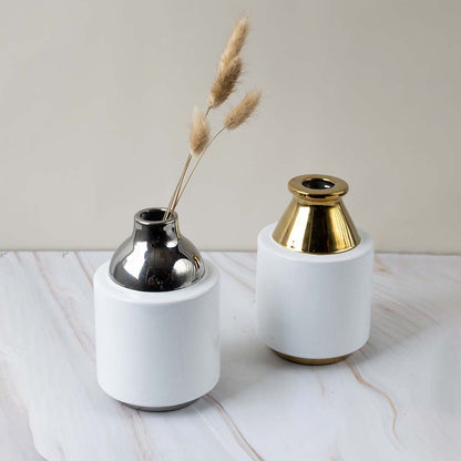 White and gold ceramic vase shown as part of a grouped decor setup adding a touch of luxury to modern home arrangements.