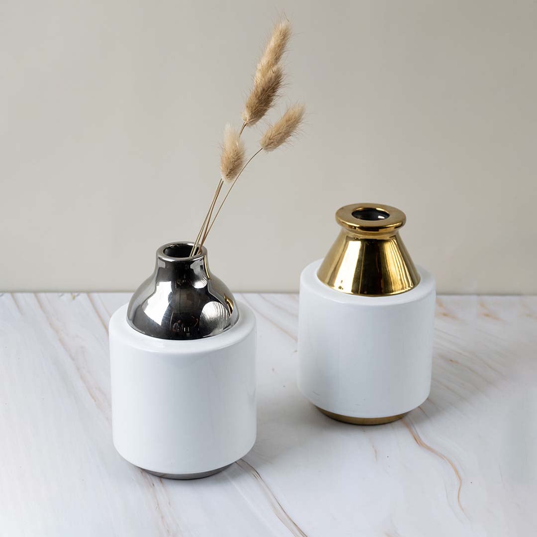 Collection of ceramic vases with glossy white body and metallic silver neck designed for stylish home interior display.