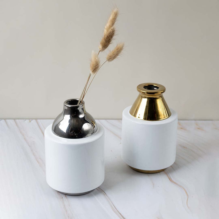 Collection of ceramic vases with glossy white body and metallic silver neck designed for stylish home interior display.