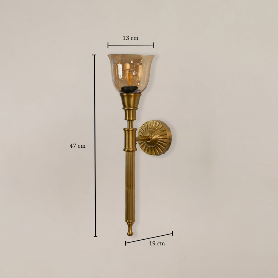 Traditional brass wall sconce with amber glass measuring 47cm height 13cm shade width and 19cm projection from wall mount.