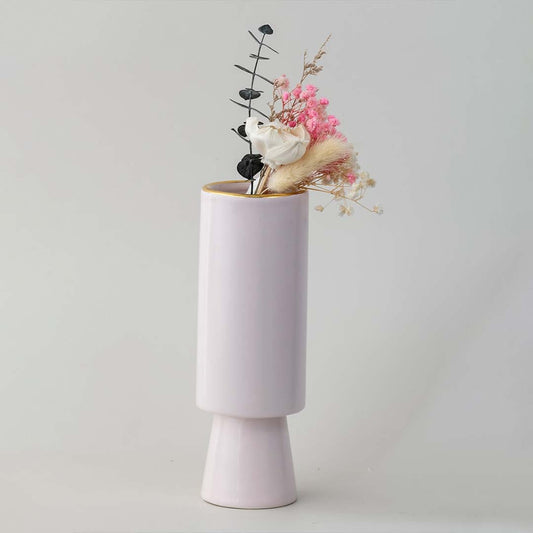 Soft toned decorative vase in blush pink shown in a minimal lifestyle scene emphasizing its sleek shape and gentle modern style.