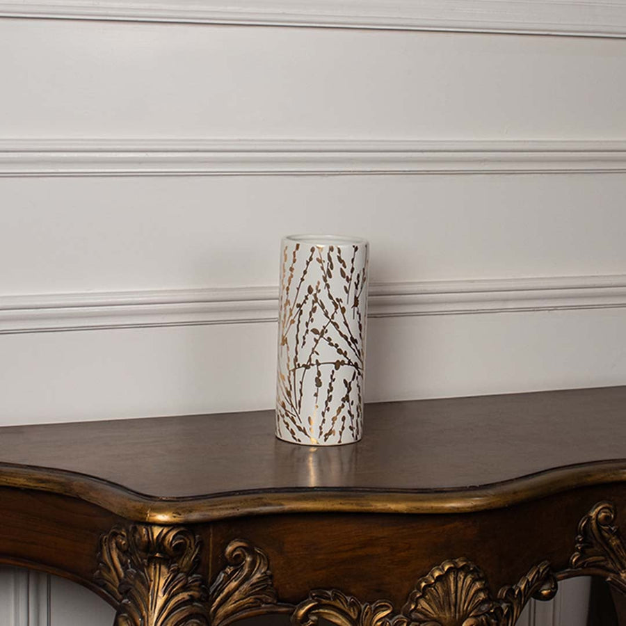 Tall white vase with ribbed detailing and gold geometric accents placed on a clean white background showcasing its minimal modern aesthetic.