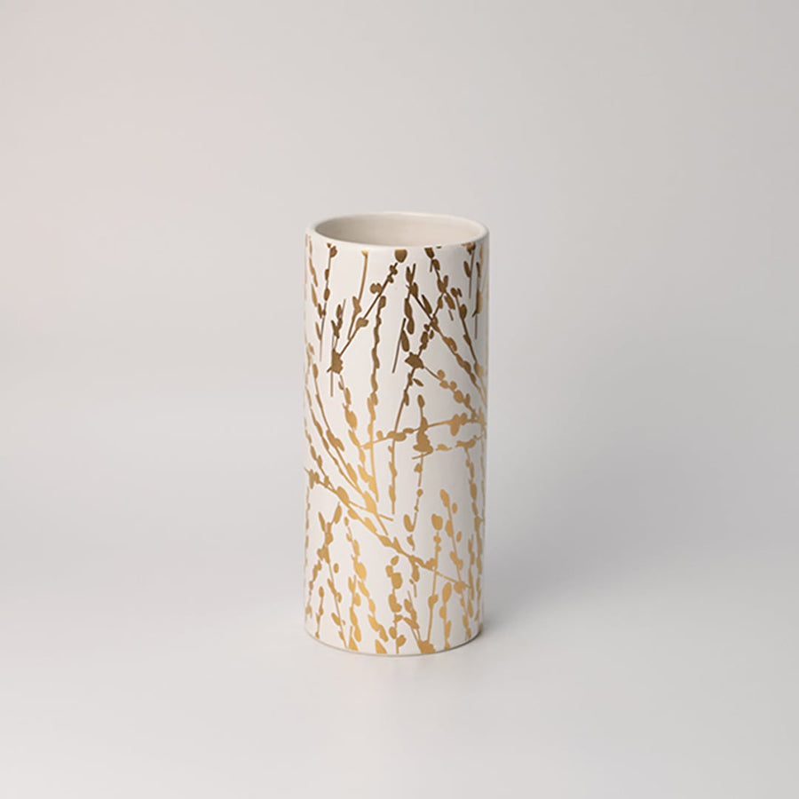 Elegant tall white vase featuring textured ribbed lines and striking gold accents photographed on a bright white surface for a crisp product display.