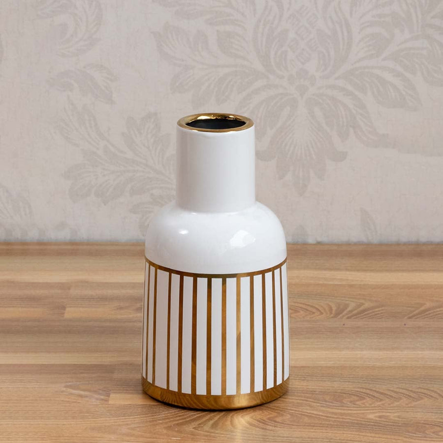 A sleek white ceramic vase accented with gold stripes photographed on a clean background highlighting its glossy finish and contemporary style.