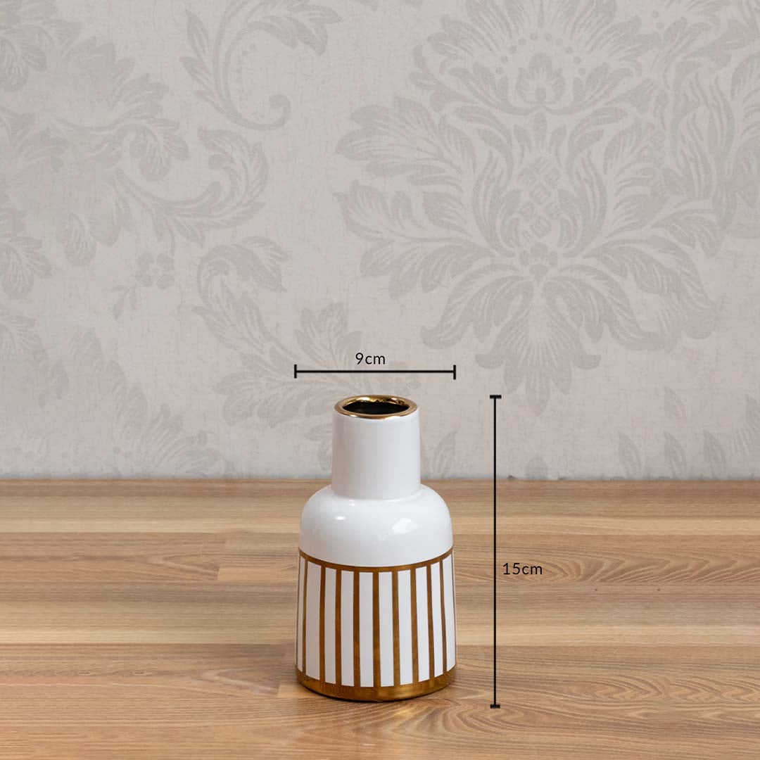 A white ceramic vase with gold detailing shown with measurements of 15 cm height and 9 cm width highlighting its compact decorative size.