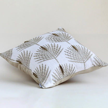 Cream cushion with textured leaf embroidery displayed on a white background highlighting its detailed stitching soft fabric texture and elegant design.