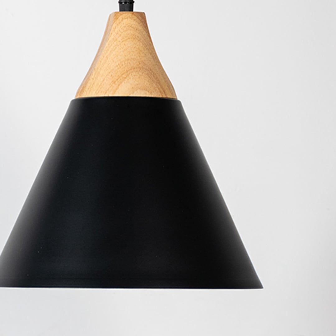 Closeup of black pendant light with wooden top showing smooth matte finish for modern home and dining lighting decor.