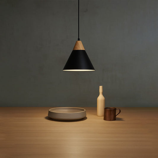 Modern pendant light with black and wood finish hanging above wooden table for dining room and kitchen lighting.