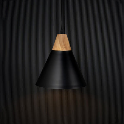 Modern black pendant light with wood top illuminated on back background for elegant dining or kitchen ceiling decor.